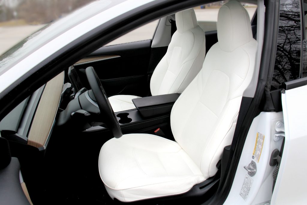 Tesla with a White Interior, and where the low-voltage power socket can be found.