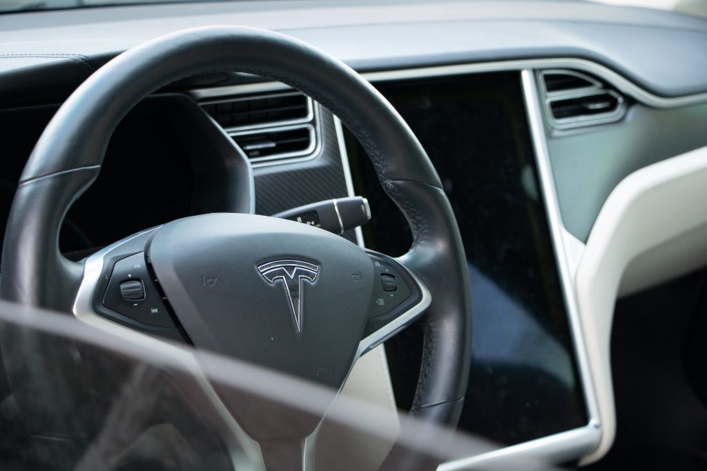 Interior of a Tesla, where Apple CarPlay and Android Auto would be used if available.