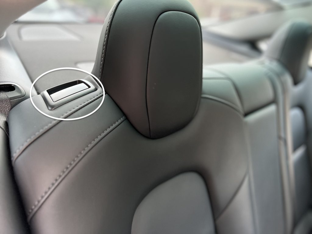 The lever to Fold Rear Seats in a Tesla Model 3 and Model Y