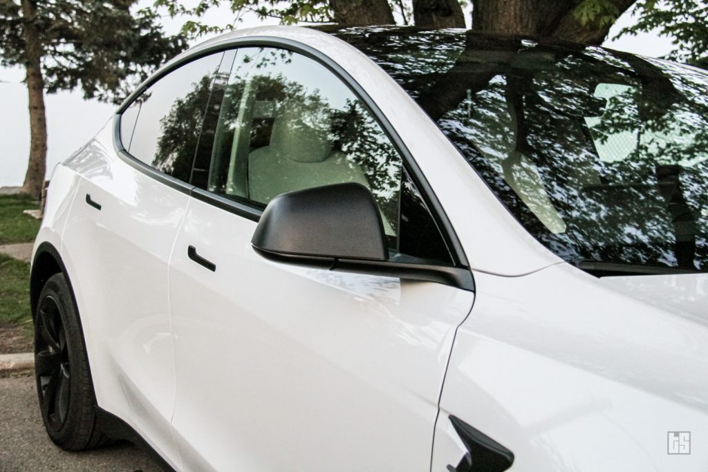 Tesloid Side Mirror Cover on a Pearl White Tesla Model Y