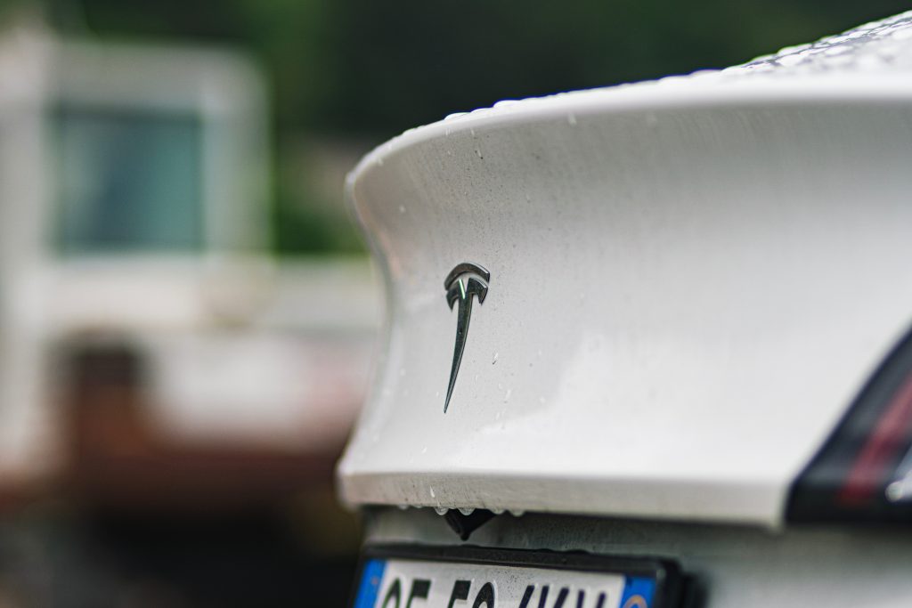 Rear Side of a Pearl White Tesla, Where the Trunk is.