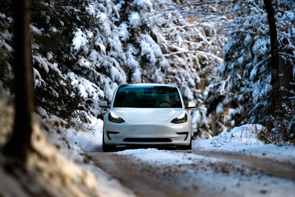 Pearl White Tesla Model 3 in a Snowy Environment