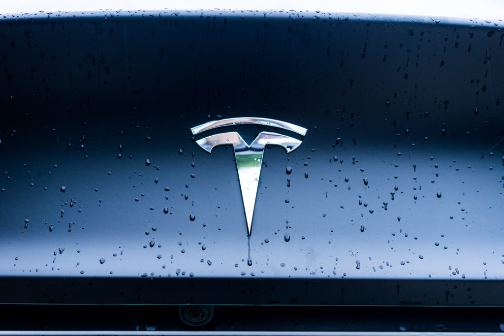 Chrome Tesla Emblem on the Back of the Car