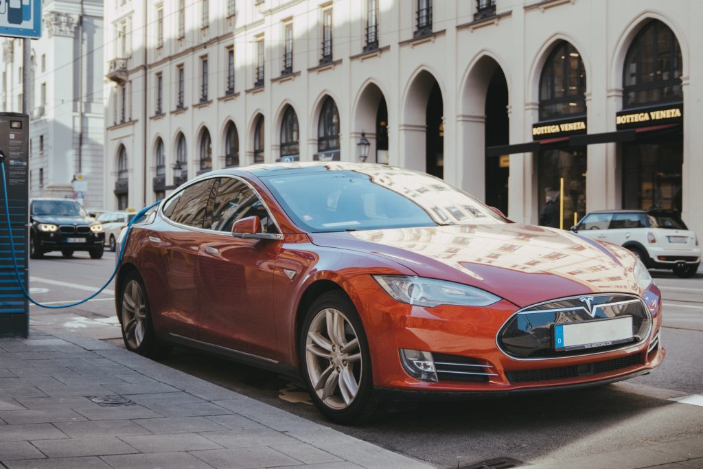 Red Tesla Model S Parked in a City