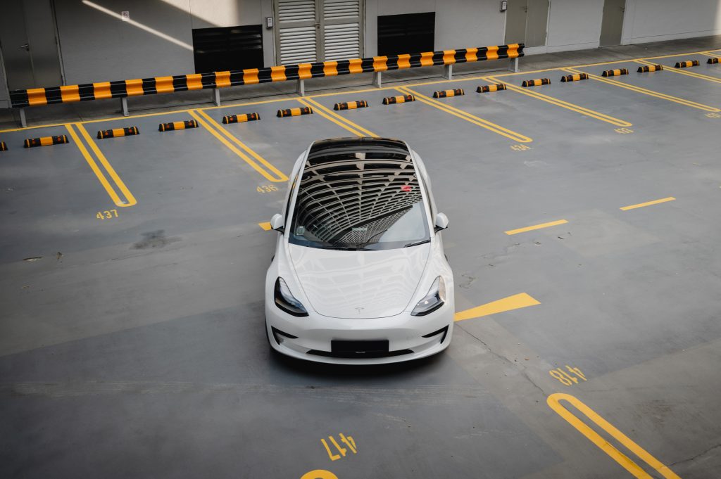 Pearl White Tesla Model 3 in a Parking Lot