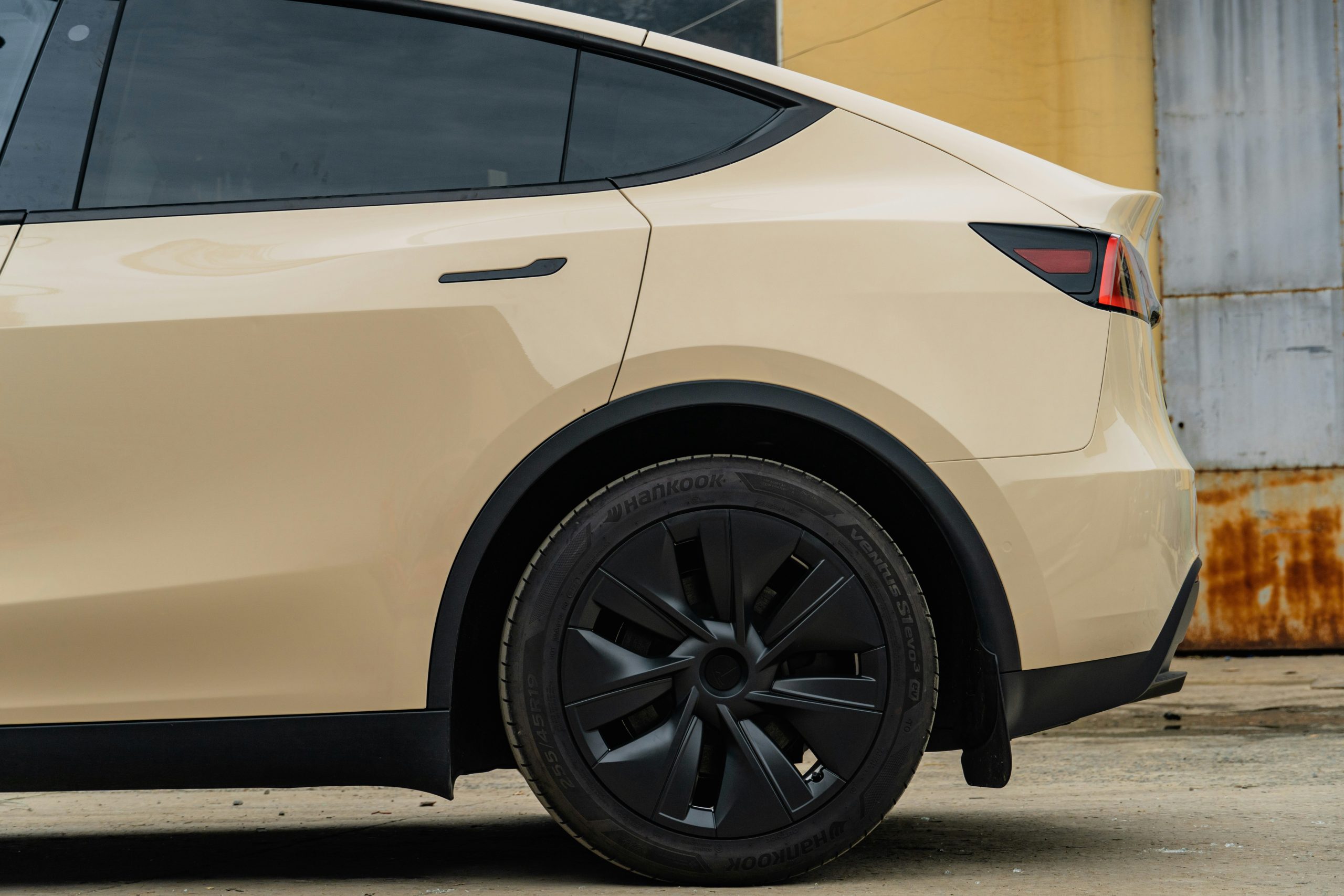 Pearl White Tesla Model Y with Tire and Wheel Displayed